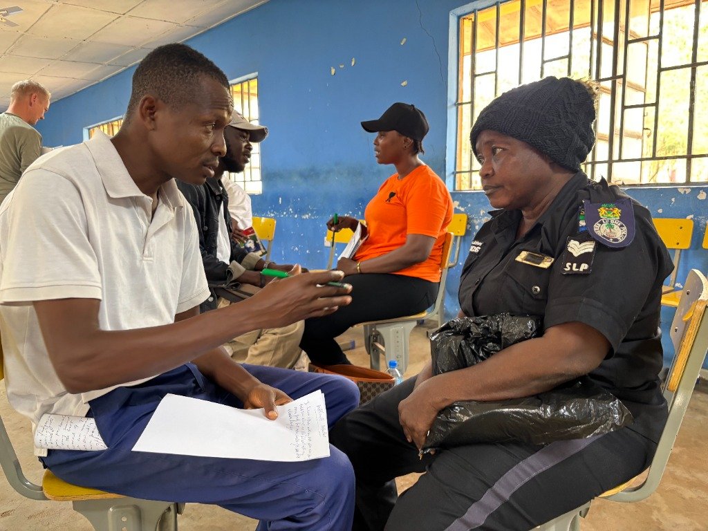 DCNCD facilitator conducting dialogue session with participant in Sierra Leone